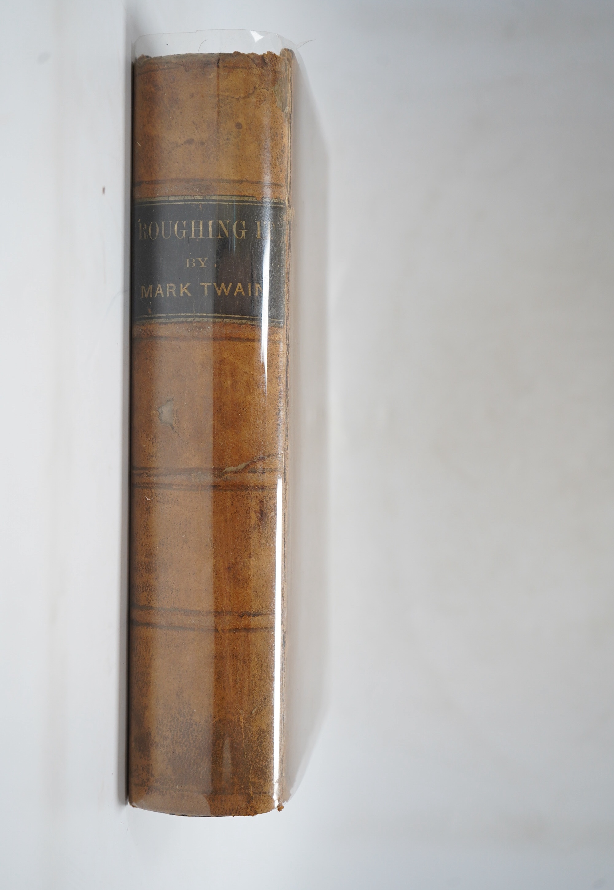 Twain, Mark [Samuel L. Clemens] - Roughing it, 8vo, calf, backstrip torn, boards scuffed, front inner hinge weak, front fly leaf with ink ownership inscription - ‘’John R. Baldwin, Christmas 1872’’, American Publishing C